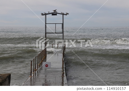 Sochi, Russia 05.07.2021. Breakwater pier summer black sea cloudy. 114910157