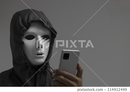 A man wearing a white mask and a smartphone 114912499