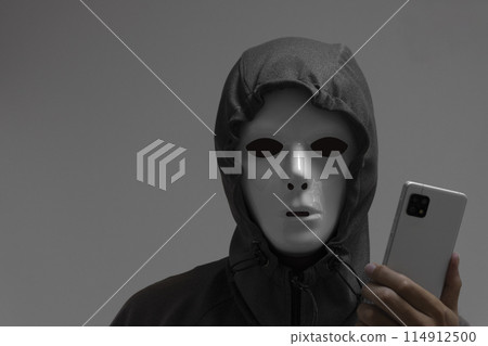 A man wearing a white mask and a smartphone 114912500