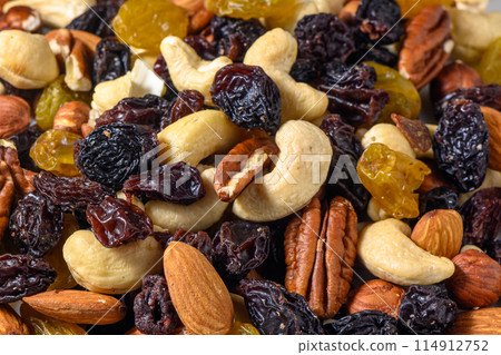 background with a cashew, hazelnuts, raisins and peanuts. Mixed nuts and raisins texture. 1 background with a cashew, hazelnuts, raisins and peanuts. Mixed nuts and raisins texture. 1 114912752