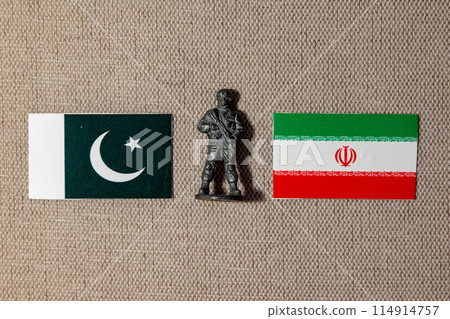 A soldier figurine on the background of the flags of Iran and Pakistan A soldier figurine on the background of the flags of Iran and Pakistan 114914757