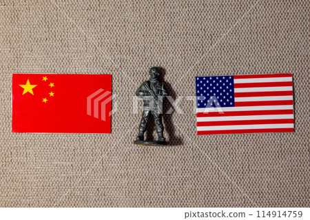 A soldier figurine on the background of the flags of the USA and China 114914759