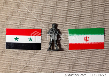 A soldier figurine on the background of the flags of Iran and Syria 114914774