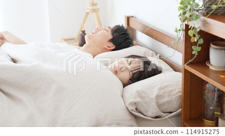 A woman who can't sleep because of loud snoring A woman who can't sleep because of loud snoring 114915275