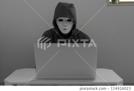 A man wearing a white mask and a laptop A man wearing a white mask and a laptop 114916023