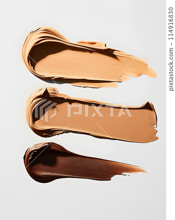 Three different shades of foundation are displayed on a clean white background Three different shades of foundation are displayed on a clean white background 114916830