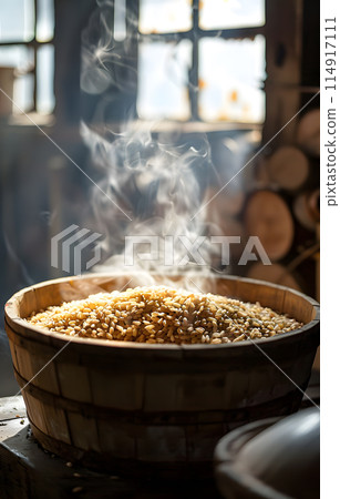 Steam rises from a wooden bowl of rice, a staple food in many cuisines around the world. This simple ingredient is a key component in countless recipes and dishes 114917111