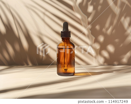 An amber glass bottle with a dropper containing a brown liquid solution is placed on a wooden table, serving as drinkware for a fluid drink An amber glass bottle with a dropper containing a brown liquid solution is placed on a wooden table, serving as drinkware for a fluid drink 114917249