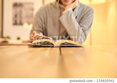 A woman reading in a room A woman reading in a room 114920542