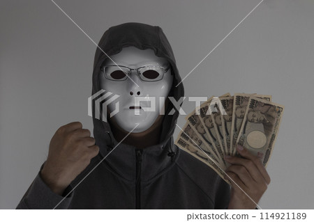 A man wearing a white mask and glasses holding money. Clenched fist A man wearing a white mask and glasses holding money. Clenched fist 114921189