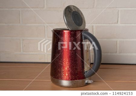 A broken old used electric kettle. Kitchen Accessories A broken old used electric kettle. Kitchen Accessories 114924153