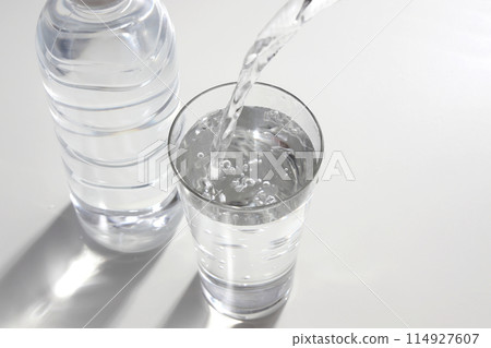 Mineral water poured into a glass 114927607