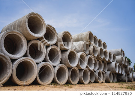 A stack of concrete ring pipes piled and creating a symmetrical arrangement 114927980
