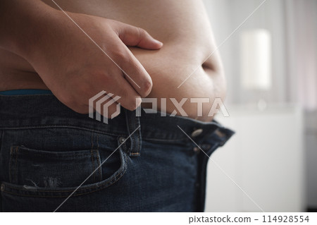 Fat bald man's belly on background of white room Fat bald man's belly on background of white room 114928554