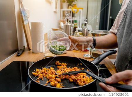 Chef at the kitchen preparing quesadillas with tofu and sweet corn Chef at the kitchen preparing quesadillas with tofu and sweet corn 114928601