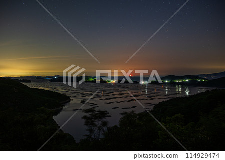 A very beautiful moon floating over the sea in Setouchi City, Okayama Prefecture, Japan 114929474