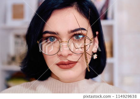 Young Woman Captured in a Beautiful Moment with Her Stick Insect (Medauroidea Extradentata) 114929638