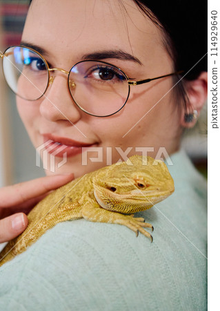 Beautiful Woman Posing with Her Adorable Bearded Dragon Pets 114929640