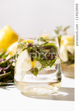 A glass of refreshing lemon water with mint A glass of refreshing lemon water with mint 114929949