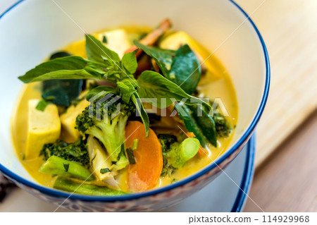 Traditional vegetable green curry with herbs and steamed rice Traditional vegetable green curry with herbs and steamed rice 114929968