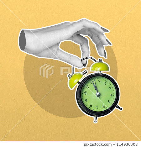 Hand setting time on a vintage alarm clock 114930308