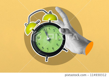 Hand holding vintage alarm clock on yellow background Hand holding vintage alarm clock on yellow background 114930312