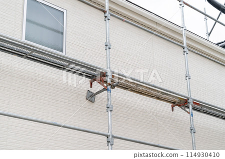 Photo of a Japanese house with scaffolding. Repairs. Photo of a Japanese house with scaffolding. Repairs. 114930410