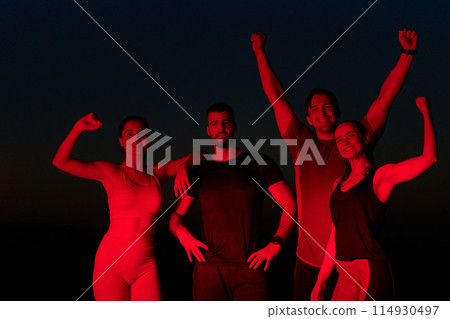 Late-Night Triumph: Group of Friends Celebrate Marathon Success. 114930497