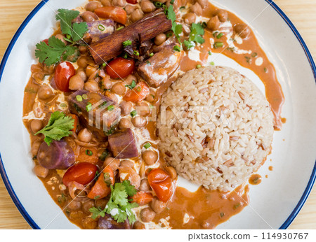 A vegetarian massaman curry in a bowl with sweet potato and many spices A vegetarian massaman curry in a bowl with sweet potato and many spices 114930767