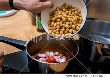 Chef at the kitchen preparing massaman curry with sweet potato and many spices Chef at the kitchen preparing massaman curry with sweet potato and many spices 114930780