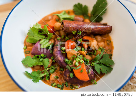 A vegetarian massaman curry in a bowl with sweet potato and many spices 114930793