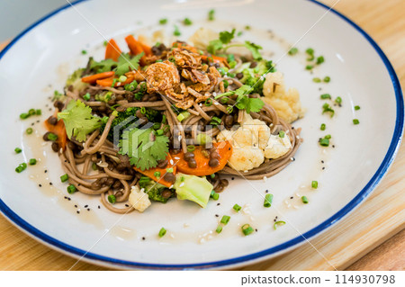 Japanese buckwheat pasta with lentils and vegetables in a bowl Japanese buckwheat pasta with lentils and vegetables in a bowl 114930798