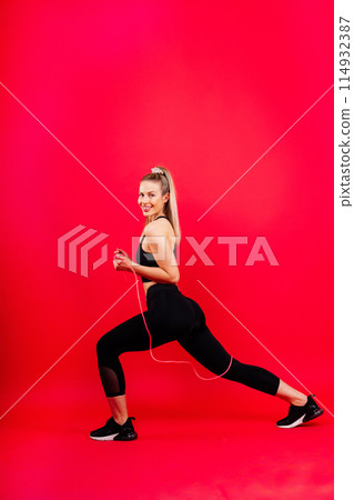 Middle aged woman doing fitness workout, standing in activewear with abs and muscles, smiling happy 114932387
