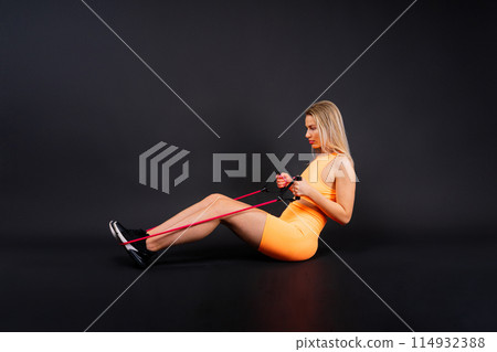 Middle aged woman doing fitness workout, standing in activewear with abs and muscles, smiling happy 114932388