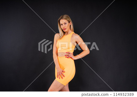 Middle aged woman doing fitness workout, standing in activewear with abs and muscles, smiling happy 114932389