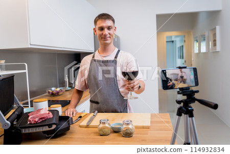 The chef is broadcasting live from workshop how to prepare a beef steaks on the electric grill 114932834