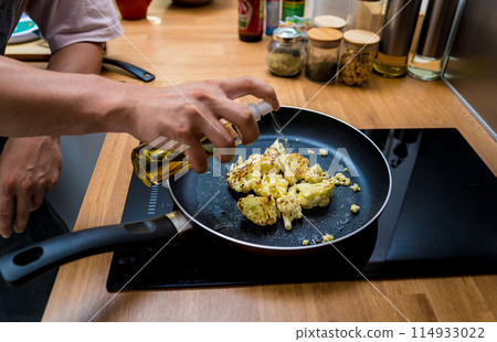 Chef at the kitchen preparing bean porridge with cauliflower and vegetables Chef at the kitchen preparing bean porridge with cauliflower and vegetables 114933022