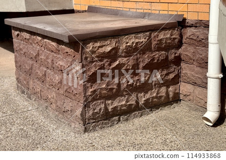 Basement entrance in the building of house has window is located below ground level. Window is covered with galvanized steel in brown color sheet to protect basement from precipitation during rain Basement entrance in the building of house has window is located below ground level. Window is covered with galvanized steel in brown color sheet to protect basement from precipitation during rain 114933868