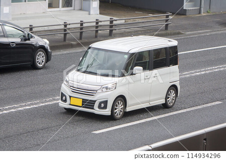 Light passenger car tall wagon road driving Light passenger car tall wagon road driving 114934296
