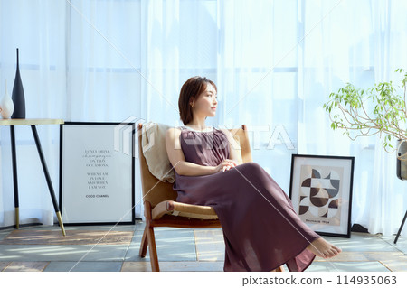 Sit in a chair in your room and relax in the morning sunshine 114935063