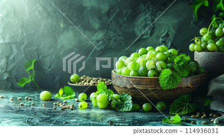 rustic wooden bowl with green grapes on dark background 114936031