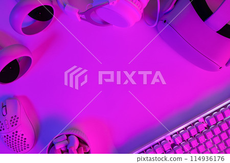 Modern gaming gadgets on purple desk Modern gaming gadgets on purple desk 114936176