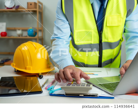 Architect or engineer using computer to work on desk, Cost calculation, Construction planning, Structural calculation, Construction cost planning, Structural design, Project presentation plan. Architect or engineer using computer to work on desk, Cost calculation, Construction planning, Structural calculation, Construction cost planning, Structural design, Project presentation plan. 114936641