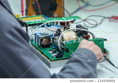 worker`s hand soldering of electronic circuit boards close-up worker`s hand soldering of electronic circuit boards close-up 114936664