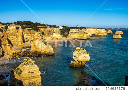 Praia da Marinha Beach among rock islets and cliffs seen from Seven Hanging Valleys Trail, Algarve, Portugal Praia da Marinha Beach among rock islets and cliffs seen from Seven Hanging Valleys Trail, Algarve, Portugal 114937176