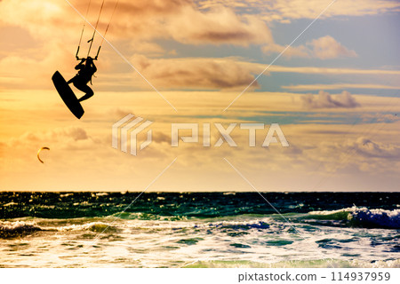 Kite surfer riding waves. Kiteboarding sport. 114937959
