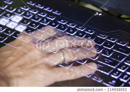 Close-up view of men's hands typing on a laptop. Relevance. Working from home, writer creating an article, browsing the internet using modern wireless technology. Transparent hands like a ghost's. 114938952