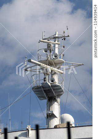 The mast of a large yacht with navigation equipment bottom view 114939414