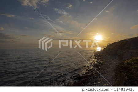 Sunset over the water against sunlight on the Black Sea Sunset over the water against sunlight on the Black Sea 114939423