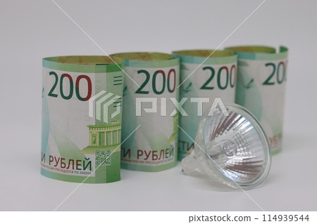 White electric cable and banknotes, expensive electricity, saving electricity. 114939544